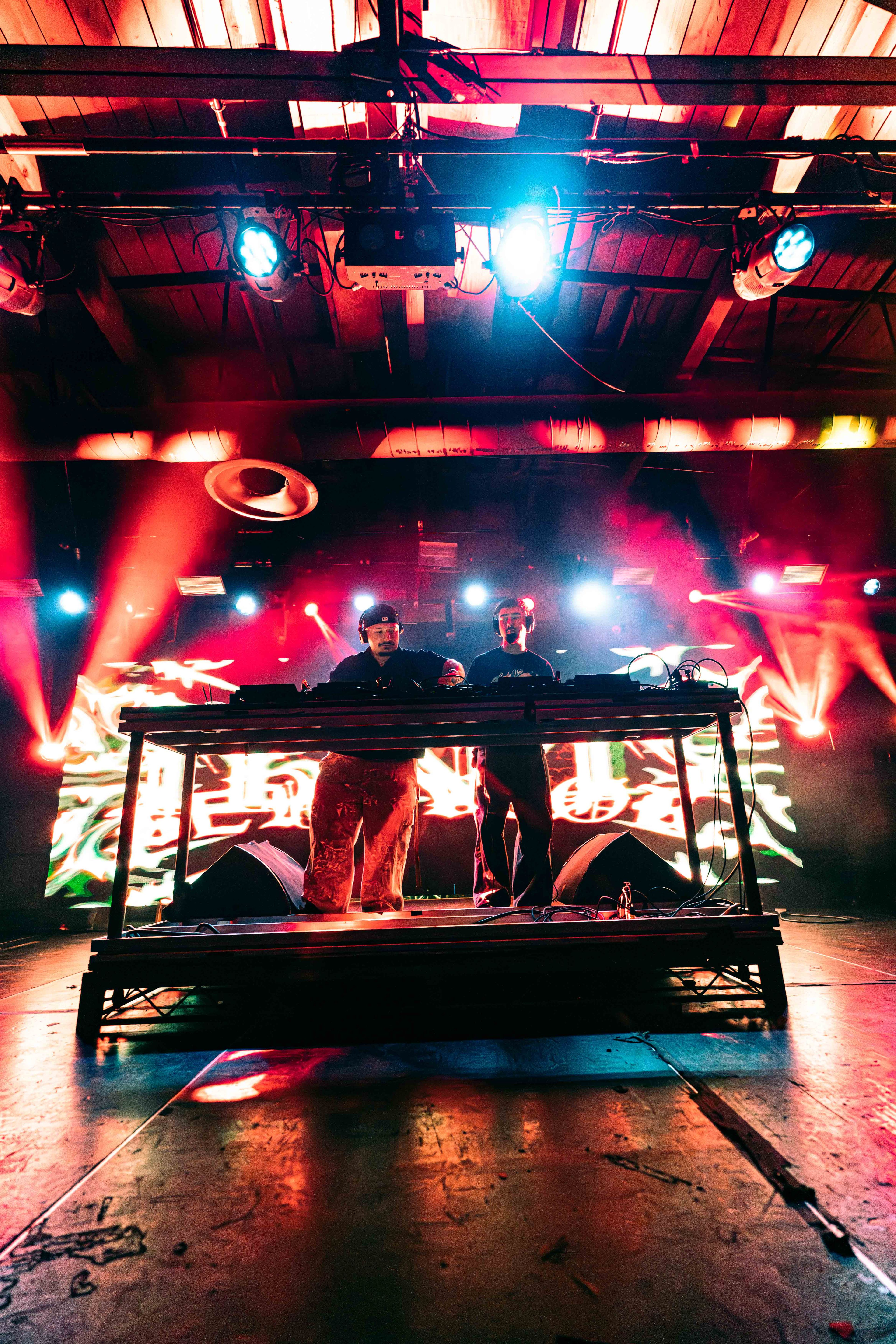 Electric guitar player with stage lights creating lens flare and dramatic shadows