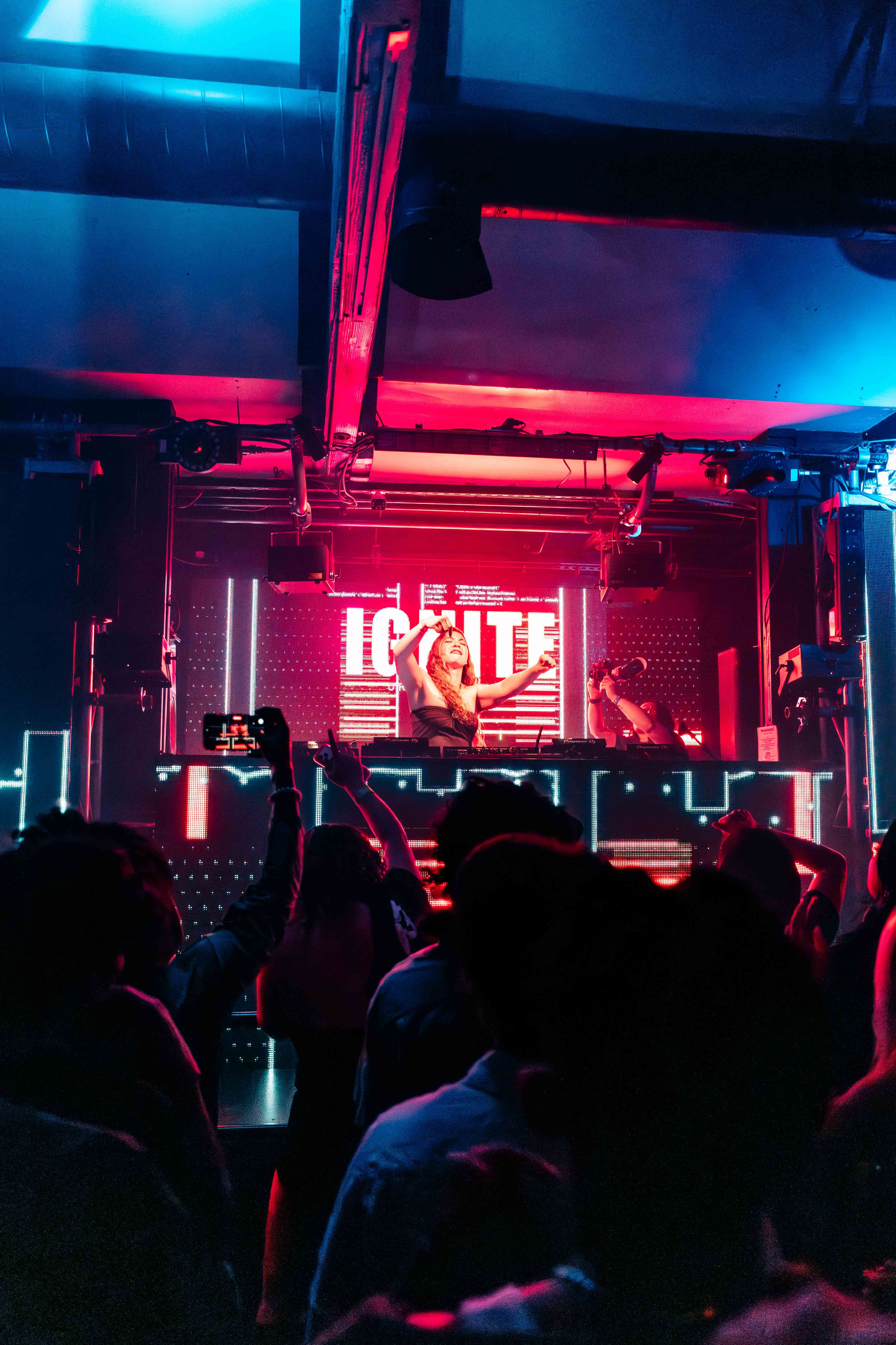 Performer on stage captured in a dynamic live concert moment