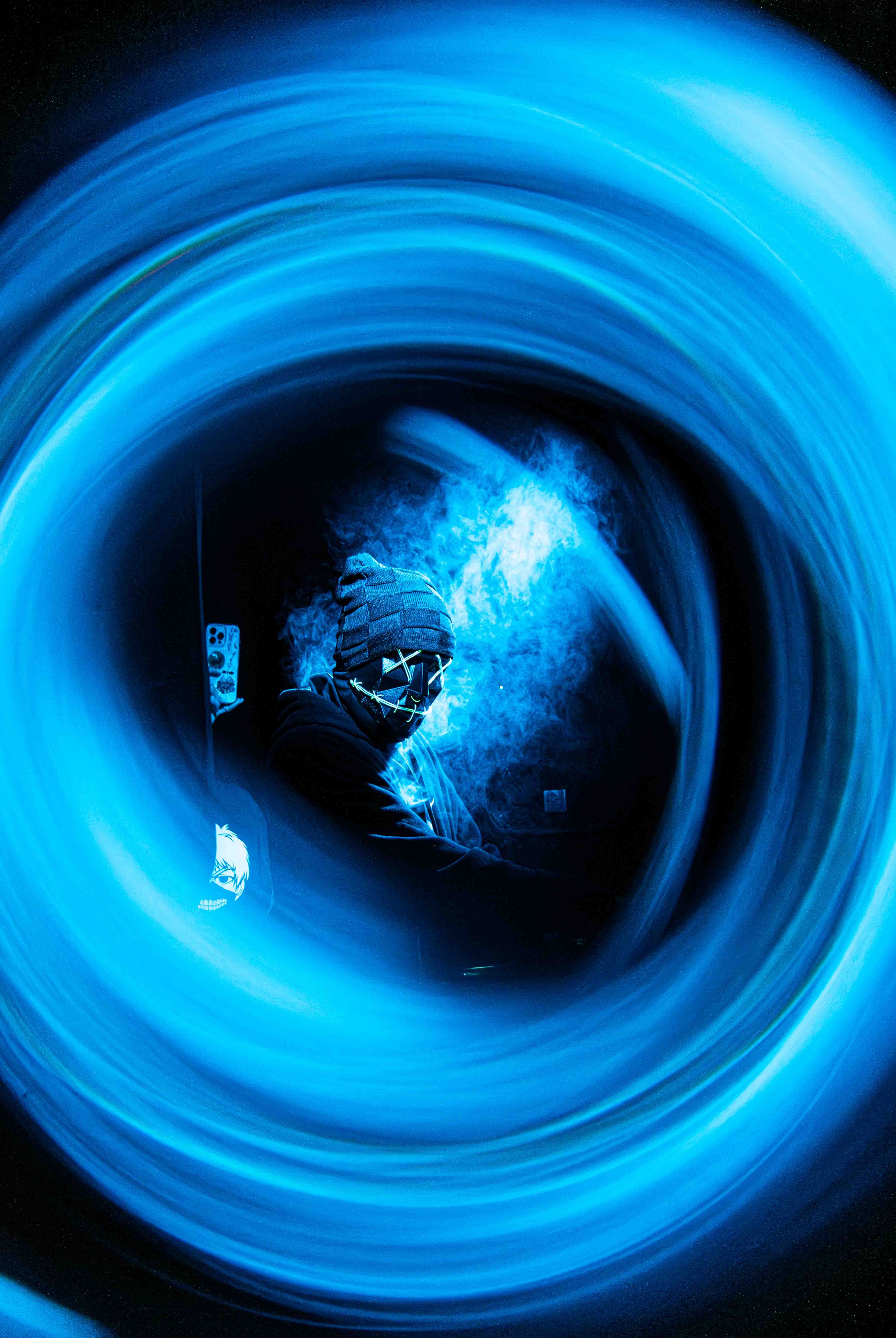 Concert performer on stage with dramatic stage lighting and crowd in the foreground